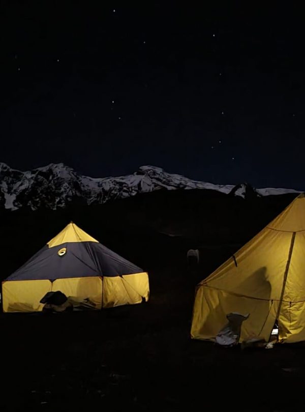 Camping by Ausangate Lagoon with reflection of snow-capped peaks