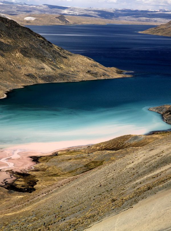 Turquoise Sibinacocha Lake surrounded by glaciers and high peaks – Peru trekking expedition