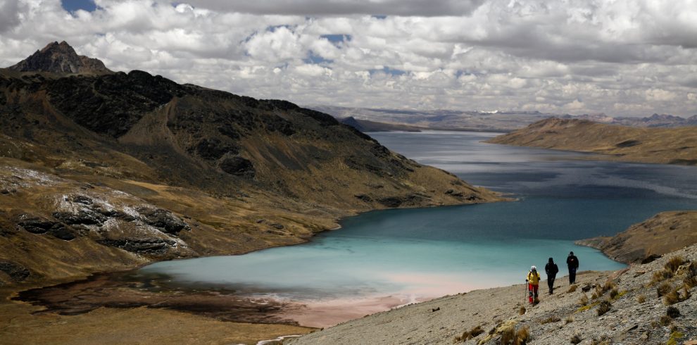 Turquoise waters of Sibinacocha Lagoon surrounded by high Andean peaks