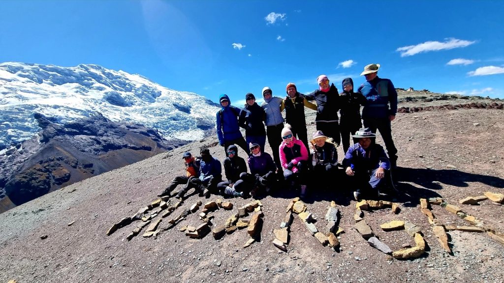 Hikers at Apacheta Viewpoint overlooking the turquoise Pucacocha Lakes during the Ausangate 2 Day Trek