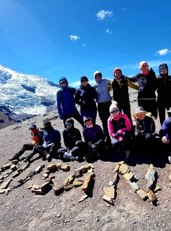 Hikers at Apacheta Viewpoint overlooking the turquoise Pucacocha Lakes during the Ausangate 2 Day Trek